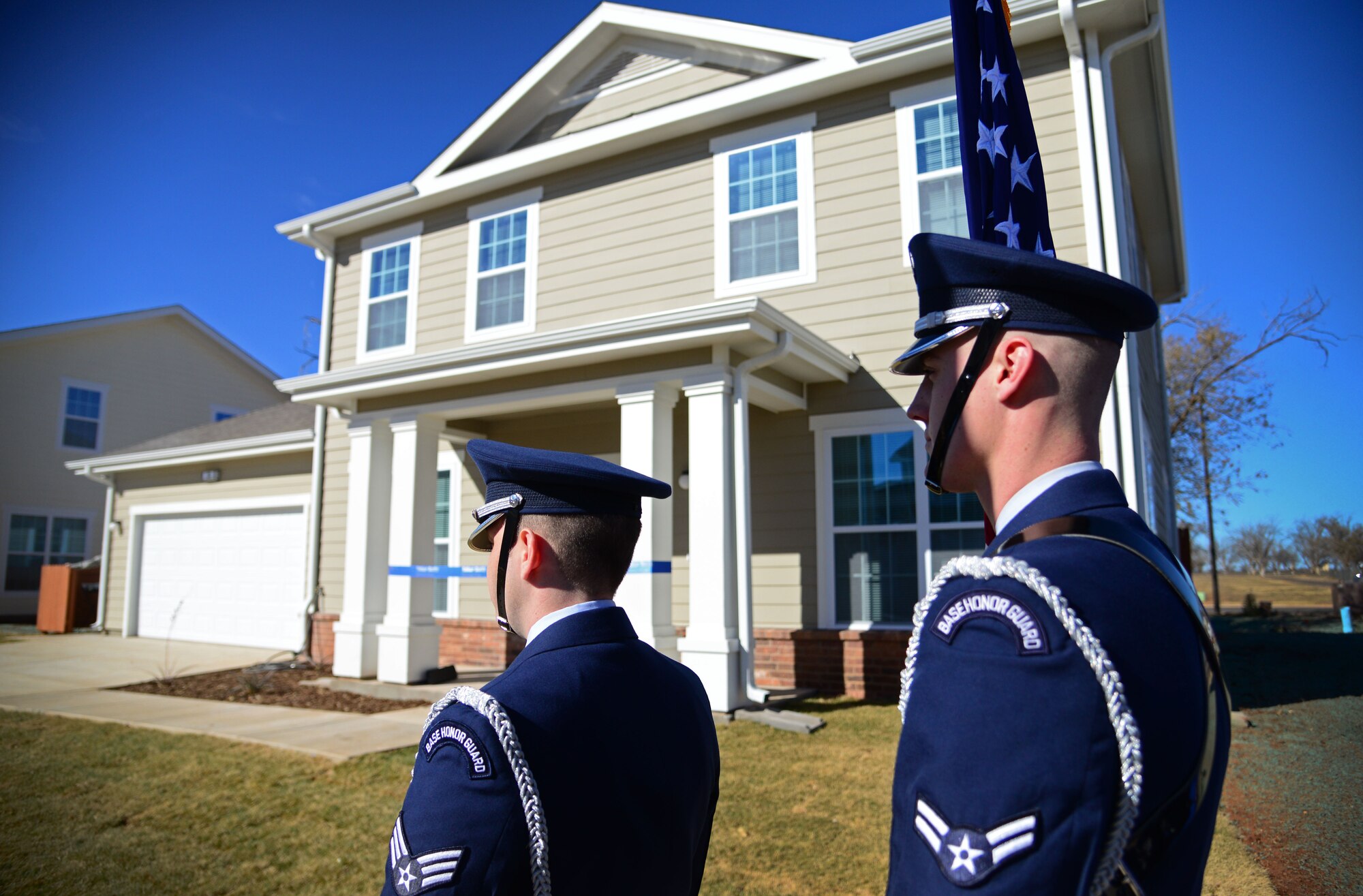 Cannon honor guardsmen stand in front of a new company grade officer home Dec. 3, 2015, at Cannon Air Force Base, N.M. A ribbon cutting ceremony was held to welcome Capt. Rex Peacock, 27th Special Operations Air Operations Squadron, and his wife to their new home. (U.S. Air Force photo/Staff Sgt. Alexx Pons) 