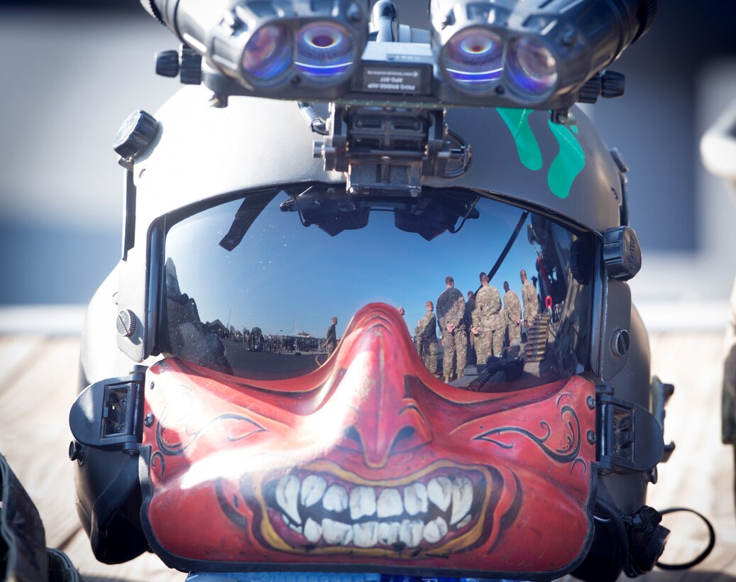 U.S. Marine Gen. Joseph F. Dunford Jr., chairman of the Joint Chiefs of Staff, brief  a U.S. Air Force HH-60 helicopter crew as seen in the reflection of an air crew member's visor during a visit to Camp Lemonnier, Djibouti, Dec 6, 2015. DoD photo by D. Myles Cullen