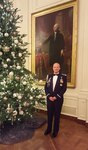 Air Force Capt. John D. Fesler waits for guests in front of a portrait of President George Washington in the East Room of the White House. Fesler is the first Airman from the Air National Guard to serve as a White House social aide.