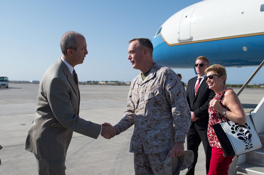 Tom Kelly, U.S. ambassador to Djibouti, greets U.S. Marine Gen. Joseph F. Dunford Jr., chairman of the Joint Chiefs of Staff, and his wife, Ellyn, upon their arrival in Djibouti, Dec. 6, 2015. The Dunfords are traveling with USO performers and visiting troops. DoD photo by D. Myles Cullen