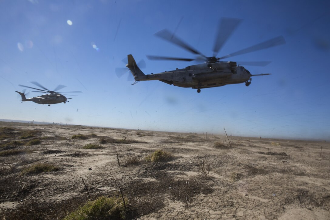 Two CH-53E Super Stallions prepare to land during section Confined Area Landings board Marine Corps Base Camp Pendleton, Calif., Dec. 2. Marines with HMH-361 conducted section Confined Area Landings and Field Carrier Landing Practices to fulfill training requirements for landing aboard a Navy ship. (U.S. Marine Corps photo by Sgt. Lillian Stephens/Released)