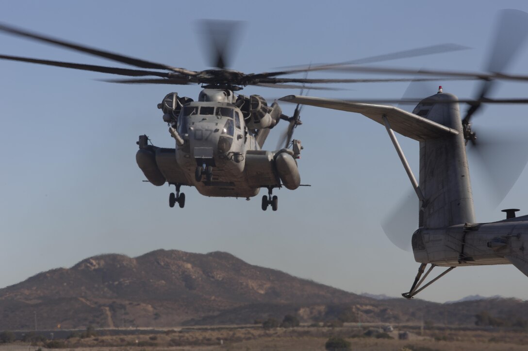 A CH-53E Super Stallion with Marine Heavy Helicopter Squadron (HMH) 361 hovers over a landing pad during Field Carrier Landing Practices aboard Marine Corps Air Station Miramar, Calif., Dec. 2. Marines with HMH-361 conducted section Confined Area Landings and Field Carrier Landing Practices to fulfill training requirements for landing aboard a Navy ship. (U.S. Marine Corps photo by Sgt. Lillian Stephens/Released)