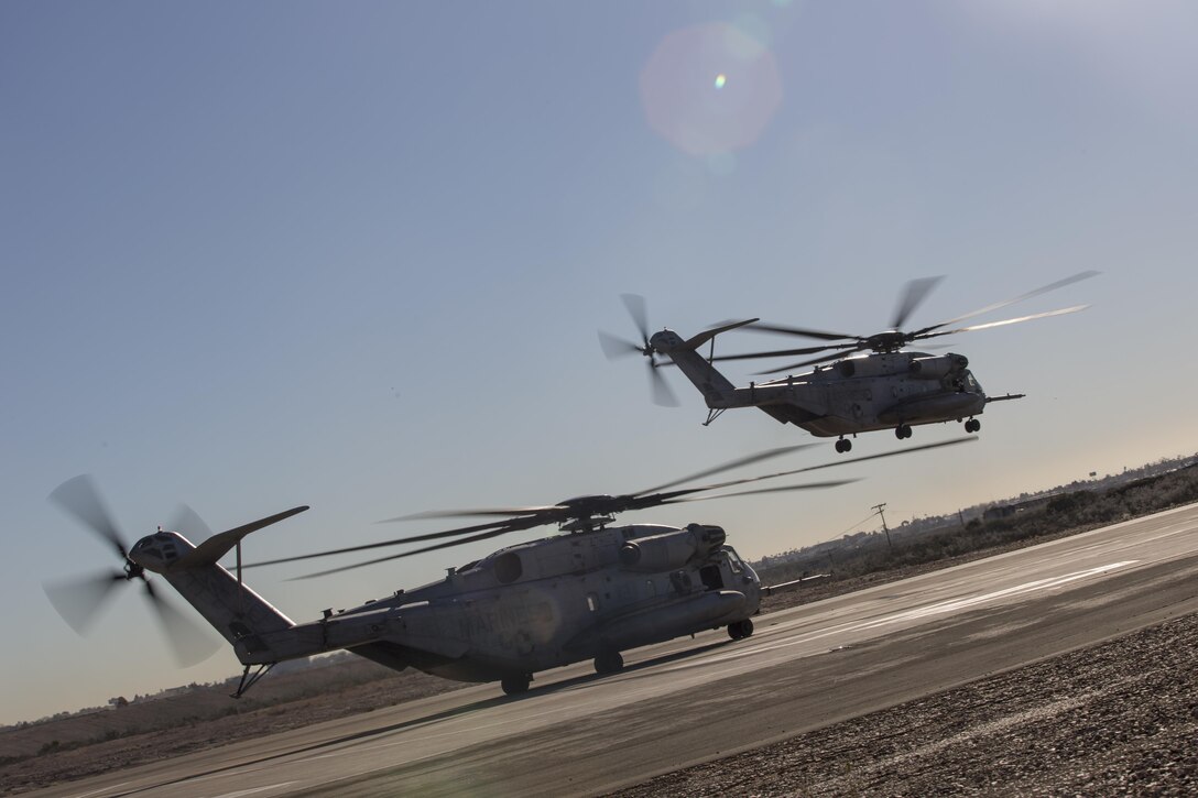 Two CH-53E Super Stallions with Marine Heavy Helicopter Squadron (HMH) 361 conduct Field Carrier Landing Practices aboard Marine Corps Air Station Miramar, Calif., Dec. 2. Marines with HMH-361 conducted section Confined Area Landings and Field Carrier Landing Practices to fulfill training requirements for landing aboard a Navy ship. (U.S. Marine Corps photo by Sgt. Lillian Stephens/Released)