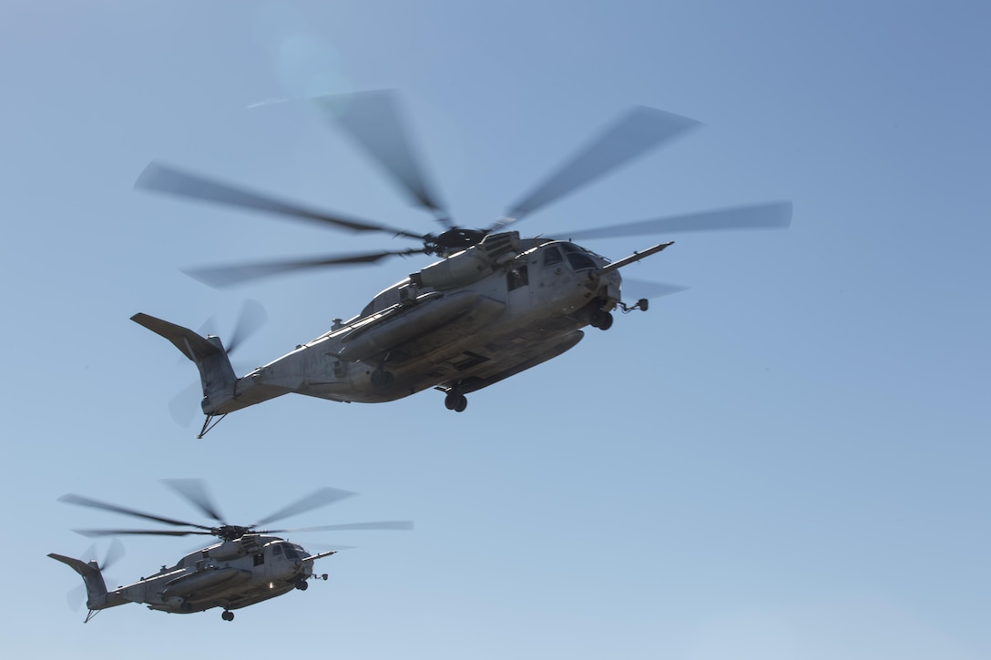 Two CH-53E Super Stallions fly over a landing zone  during section Confined Area Landings board Marine Corps Base Camp Pendleton, Calif., Dec. 2. Marines with HMH-361 conducted section Confined Area Landings and Field Carrier Landing Practices to fulfill training requirements for landing aboard a Navy ship. (U.S. Marine Corps photo by Sgt. Lillian Stephens/Released)
