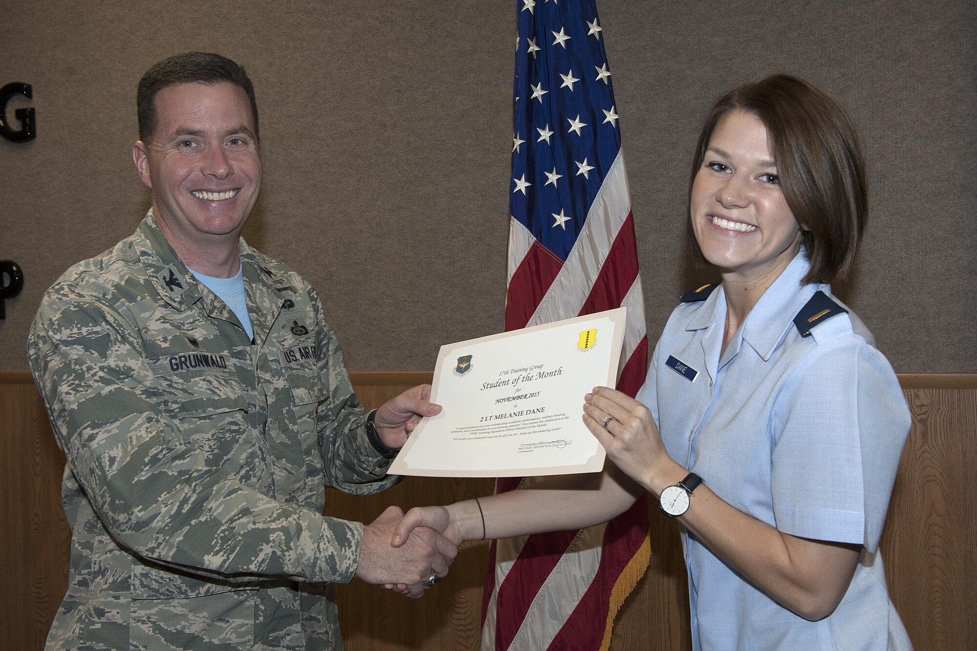 U.S. Air Force Col. Michael Grunwald Jr., 17th Training Group Commander, presents the 315th Training Squadron Officer Student of the Month award for December 2015 to 2nd Lt. Melanie Dane in the Brandenburg Hall on Goodfellow Air Force Base, Texas, Dec. 4, 2015. (U.S. Air Force photo by Airman 1st Class Caelynn Ferguson/Released)