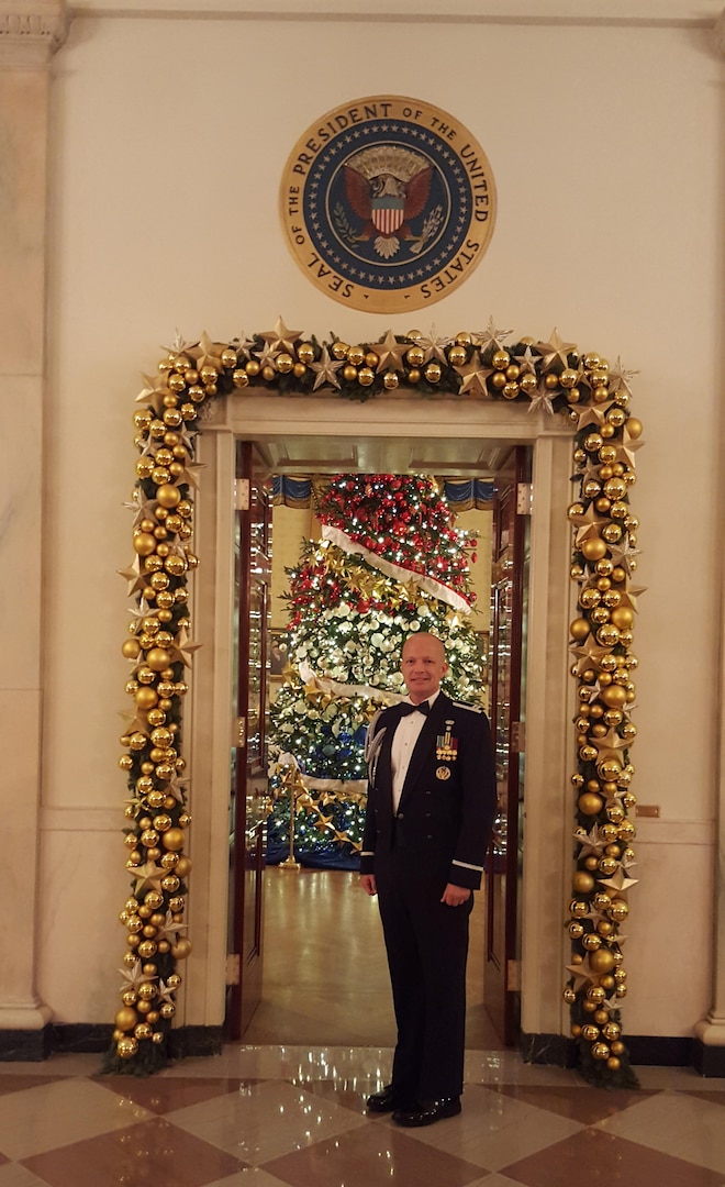 Air Force Capt. John D. Fesler stands in front the doorway to the Blue Room in Cross Hall of the White House. Fesler is the first Airman from the Air National Guard to serve as a White House social aide.