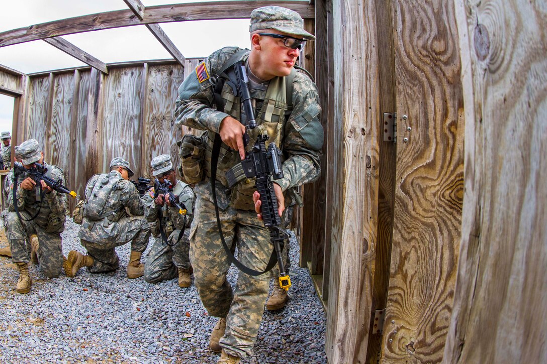 A soldier enters a second room as other soldiers provide cover while rehearsing room clearance procedures at the Urban Assault Course on Fort Jackson, S.C., Dec. 3, 2015. U.S. Army photo by Sgt. 1st Class Brian Hamilton