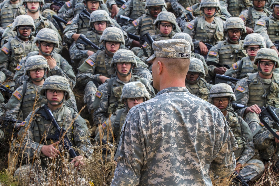 An Army drill sergeant, foreground, briefs his soldiers before rehearsing individual movement techniques in preparation for night infiltration training on Fort Jackson, S.C., Dec. 3, 2015. U.S. Army photo by Sgt. 1st Class Brian Hamilton