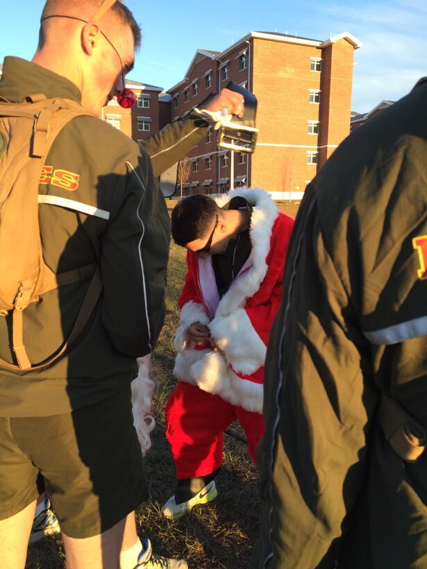 As part of the Holiday Fun Run at Courthouse Bay, Camp Lejeune, N.C. on Dec. 4, 2015; Marines of Marine Corps Engineer School competed in the Commanding Officer's Holiday Sleigh Relay Race in which teams of Marines from each company constructed a sleigh with provided materials, company commanders, company first sergeants and Marines donned costumes; and then the teams raced across the parade field.  Captain Zack A. Pinkerton dons a Santa suit as part of the relay race.
