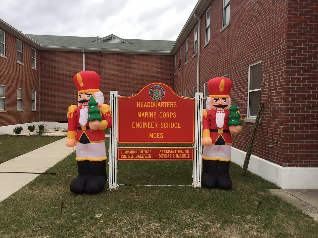 Marines and Family Readiness volunteers place holiday decorations around Marine Corps Engineer School to spread holiday cheer at Courthouse Bay, Camp Lejeune, N.C.