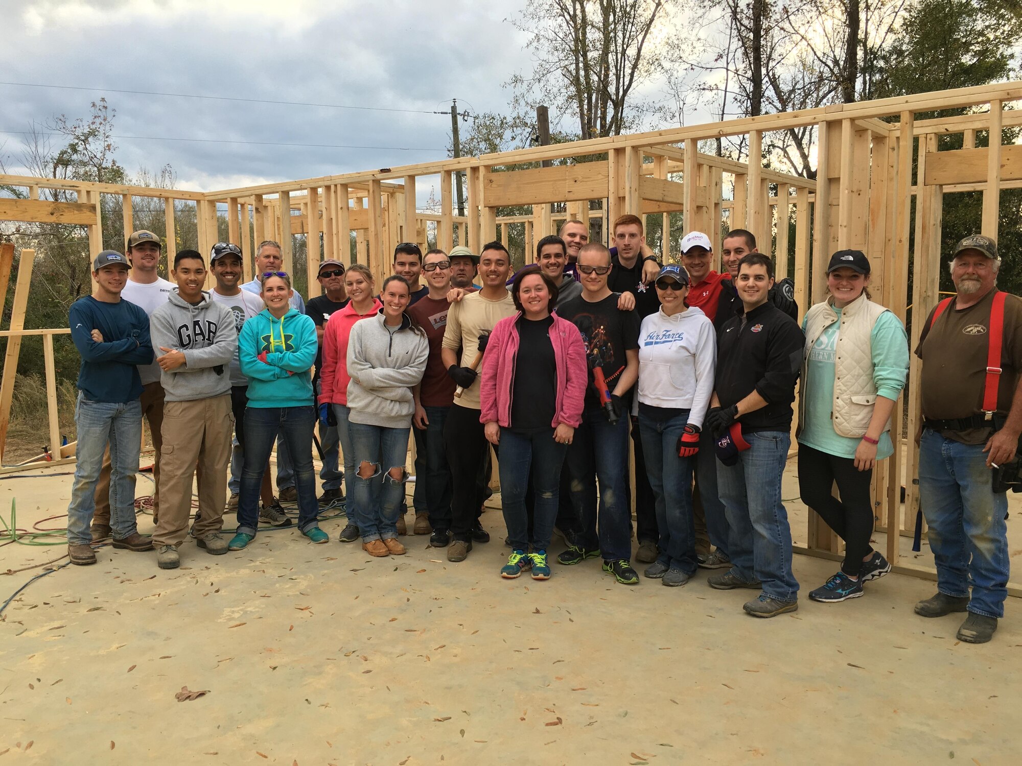 Specialized Undergraduate Pilot Training Class 17-02 members pose for a photo Nov. 21 with Habitat for Humanity, its beneficiaries and the contractors involved in building a home in Columbus, Mississippi. The officers constructed all of the framing for the four-bedroom, two-bathroom house under the guidance of local licensed contractors who spearheaded the construction effort. (Courtesy photo)