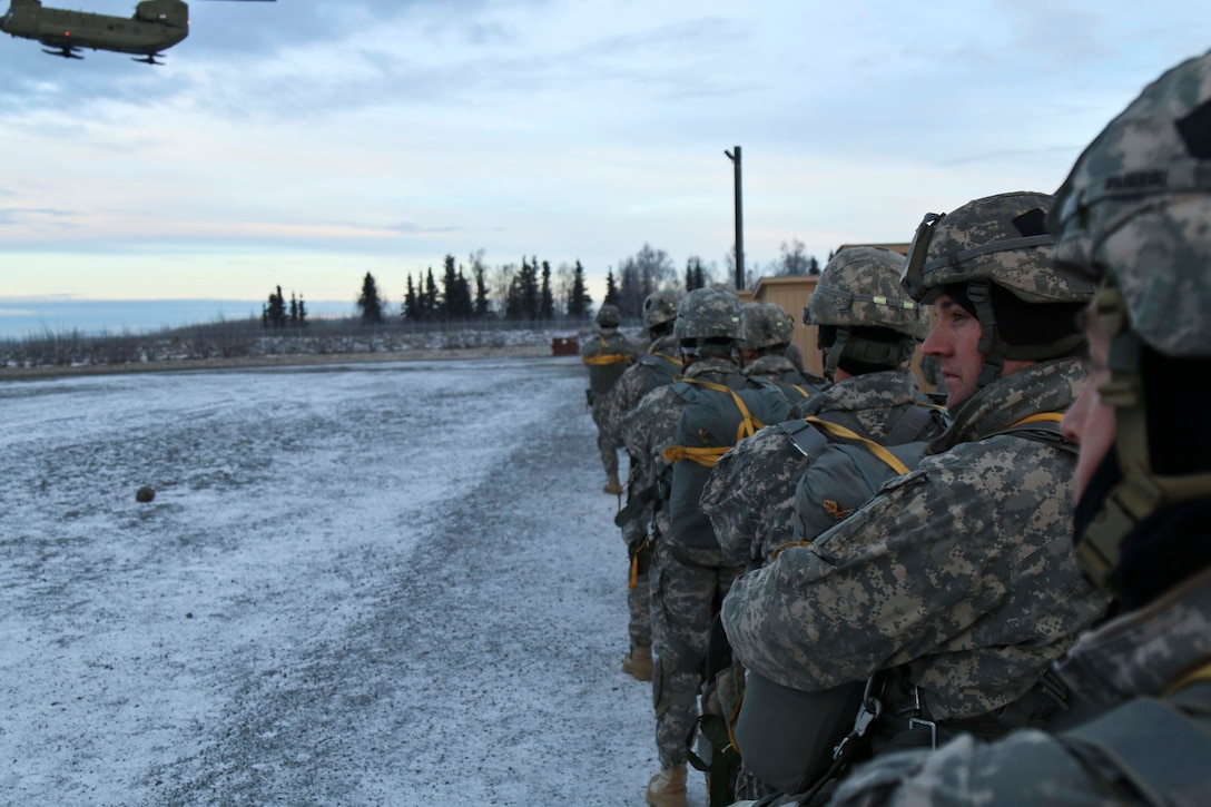 Paratroopers wait to board a CH-47 Chinook helicopter at Forward Operating Base Sparta on Joint Base Elmendorf-Richardson, Alaska, Dec. 3, 2015. U.S. Army photo by Staff Sgt. Brian Ragin