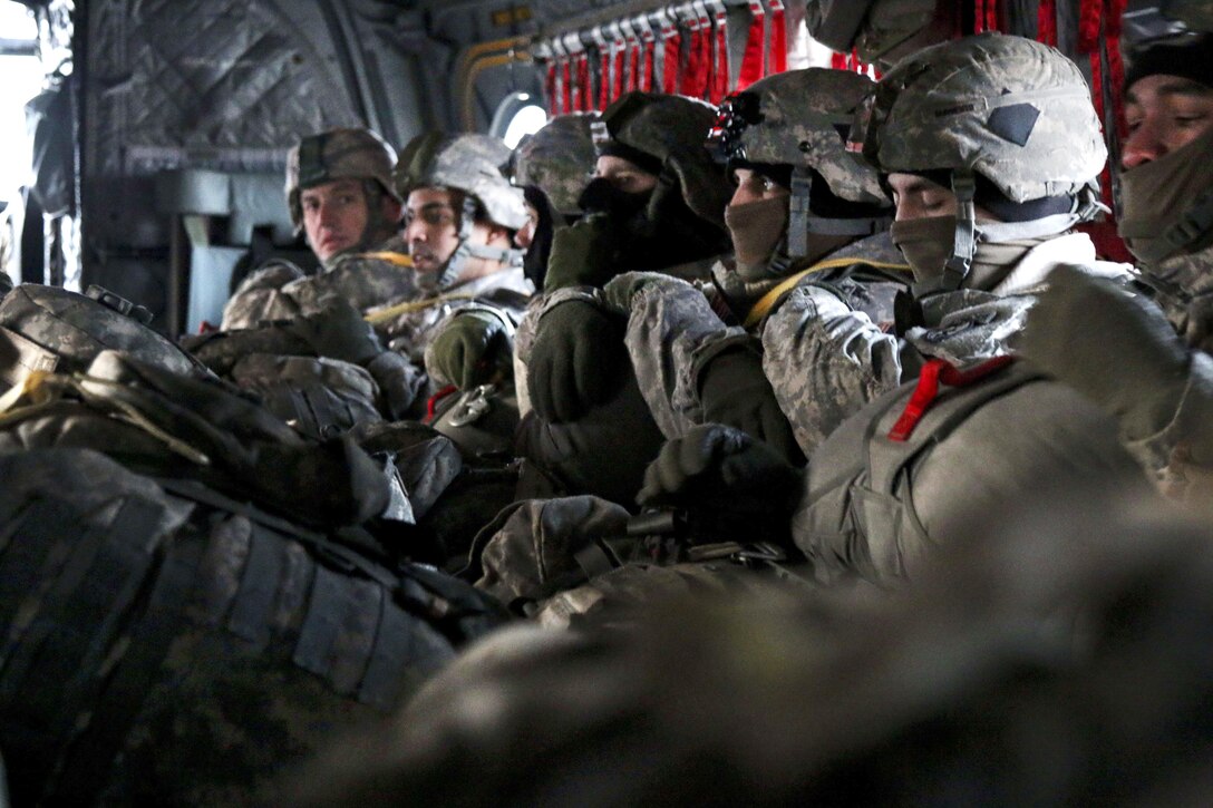 Paratroopers sit inside a CH-47 Chinook helicopter and wait for take-off at Forward Operating Base Sparta on Joint Base Elmendorf-Richardson, Alaska, Dec. 3, 2015. U.S. Army photo by Staff Sgt. Brian Ragin