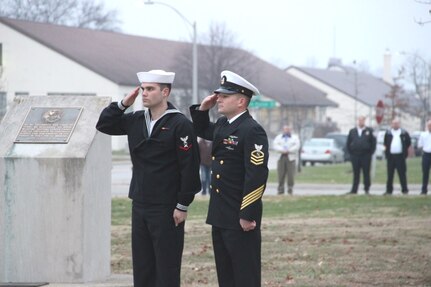 151207-N-QI541-081 - Sailors salute the morning colors at the ceremony honoring the 74th anniversary of the attacks on Pearl Harbor.