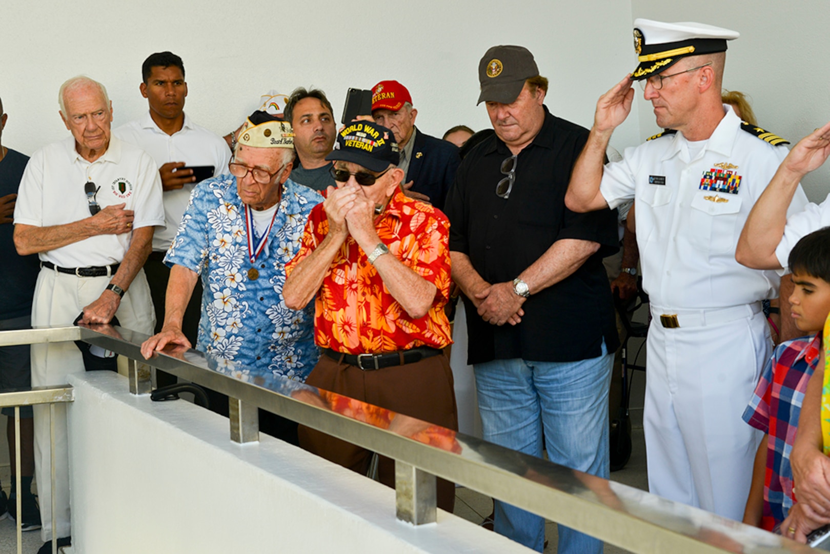 PEARL HARBOR (Dec. 5, 2015) Peter B. Dupre', a World War II Veteran, plays taps on his harmonica during a floral tribute aboard the USS Arizona Memorial on Joint Base Pearl Harbor-Hickam (JBPHH). The floral tribute was part of Pearl Harbor Survivor/ World War II Family and Friends Harbor Tour that took place at JBPHH. Several events that will take place leading up to the 74th anniversary of Pearl Harbor Day to pay tribute to the nationÕs military while enlightening Americans about veterans and service. 