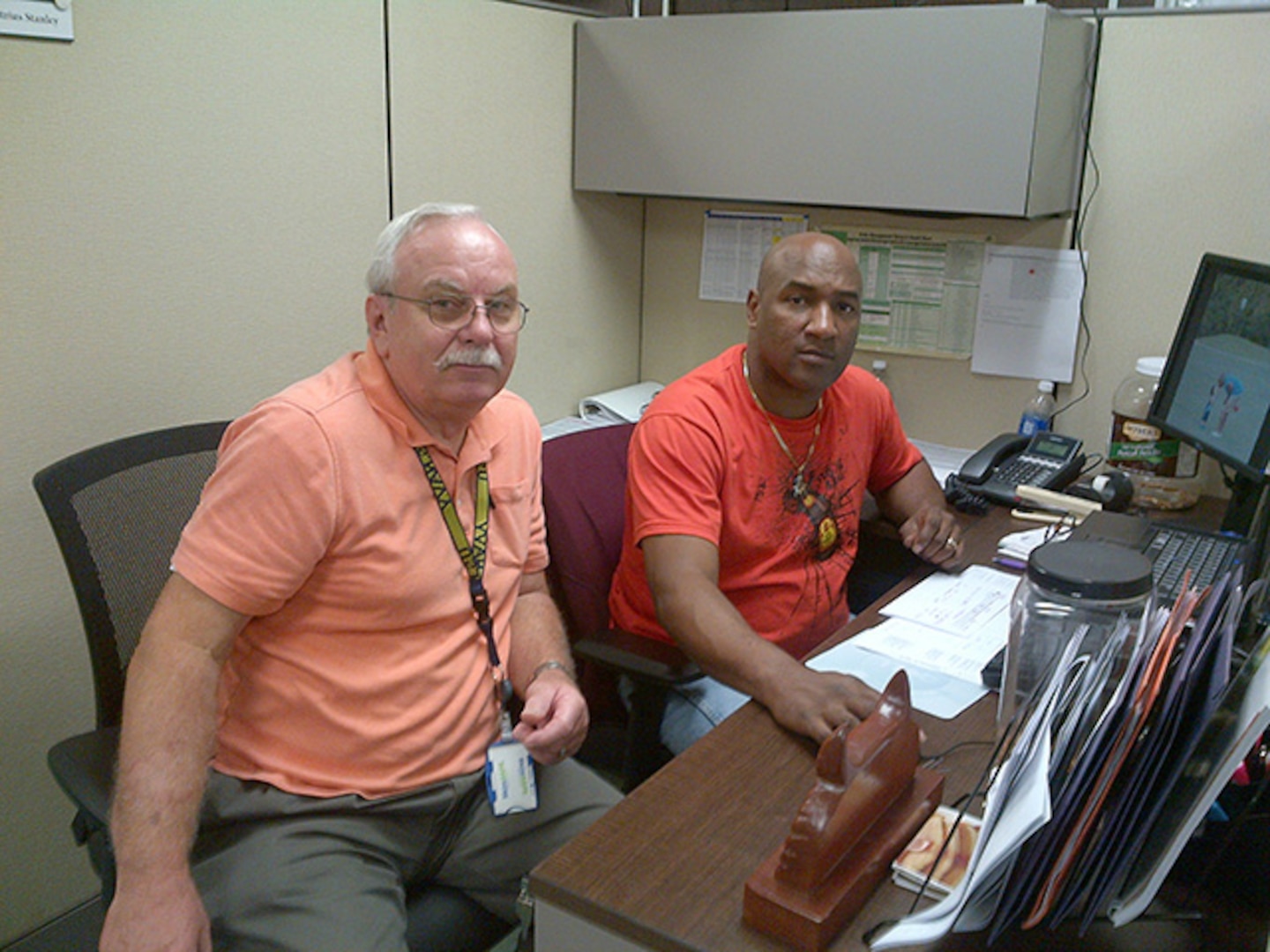 DLA Aviation at Jacksonville employees Carl Shinn and Demetrius Stanley take a break Dec. 2, 2015 to pose for a picture in their newly renovated F/A 18 Material Support Office on Fleet Readiness Center Southeast, Jacksonville, Florida. 