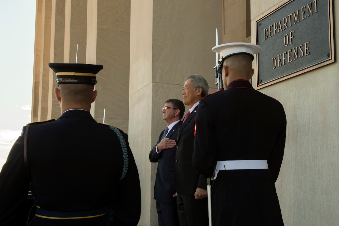 U.S. Defense Secretary Ash Carter renders honors as the national anthem is played during an enhanced honor cordon welcoming Singaporean Defense Minister Ng Eng Hen to the Pentagon, Dec. 7, 2015. The two leaders met to discuss matters of mutual importance. DoD photo by Air Force Senior Master Sgt. Adrian Cadiz