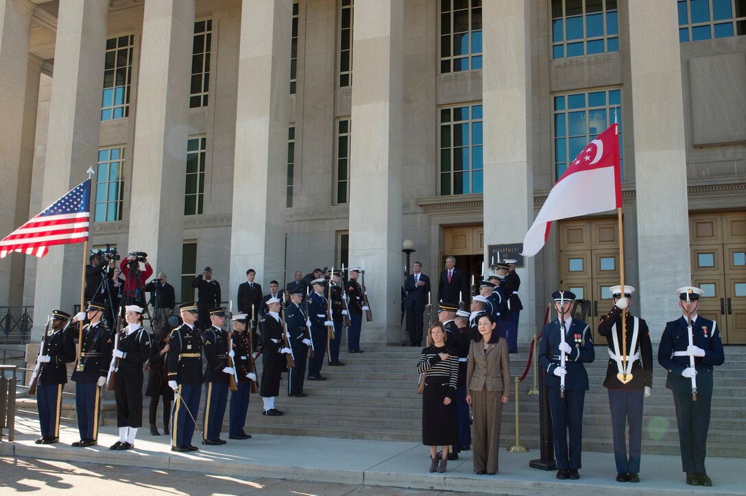 U.S. Defense Secretary Ash Carter renders honors as the national anthem is played during an enhanced honor cordon welcoming Singaporean Defense Minister Ng Eng Hen to the Pentagon, Dec. 7, 2015. The two leaders met to discuss matters of mutual importance. DoD photo by Air Force Senior Master Sgt. Adrian Cadiz