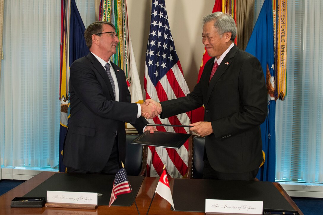 U.S. Defense Secretary Ash Carter and Singaporean Defense Minister Ng Eng Hen shake hands after signing the Enhanced Defense Cooperation Agreement during a meeting at the Pentagon, Dec. 7, 2015. DoD photo by Air Force Senior Master Sgt. Adrian Cadiz