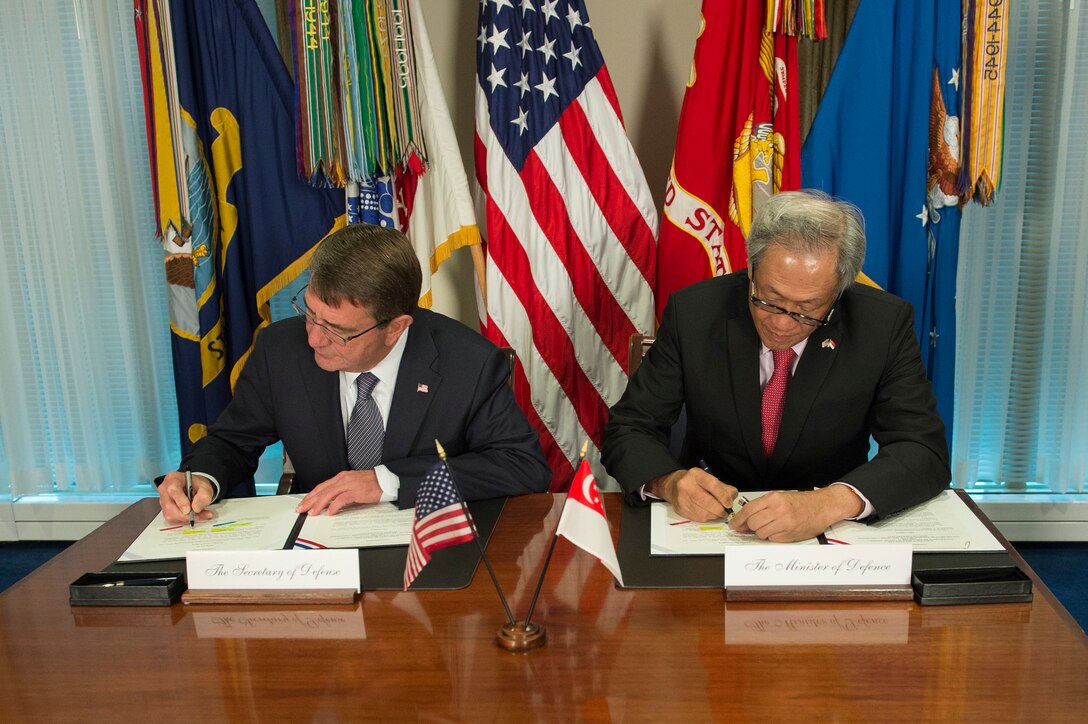 U.S. Defense Secretary Ash Carter and Singaporean Defense Minister Ng Eng Hen sign the Enhanced Defense Cooperation Agreement during a meeting at the Pentagon, Dec. 7, 2015. DoD photo by Air Force Senior Master Sgt. Adrian Cadiz