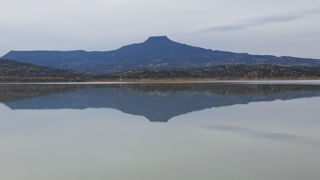ABIQUIU LAKE, N.M. – Cerro Pedernal reflects in Abiquiu Lake. Photo by Jeremy Decker, Oct. 28, 2015.  This was a 2015 Photo Drive entry.