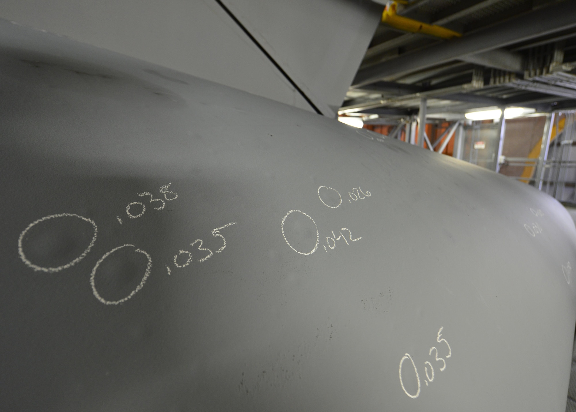 Dents on a C-5M Super Galaxy are circled and measured while the aircraft undergoes a MSG-3 Major inspection Dec. 2, 2015, in a isochronal dock at Dover Air Force Base, Del. Once identified, dents are patched and repaired during the inspection. (U.S. Air Force photo/Senior Airman William Johnson)