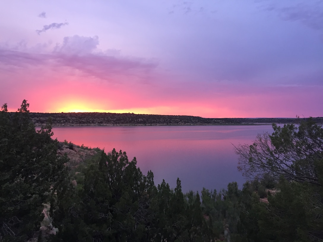 CONCHAS LAKE, N.M. – Photo of a sunset taken on the north side of the lake. Just as the sun was about to go down, it cast beautiful shades of pink and purple on the water. Photo by Nadine Carter, June 26, 2015. This was a 2015 Photo Drive entry.