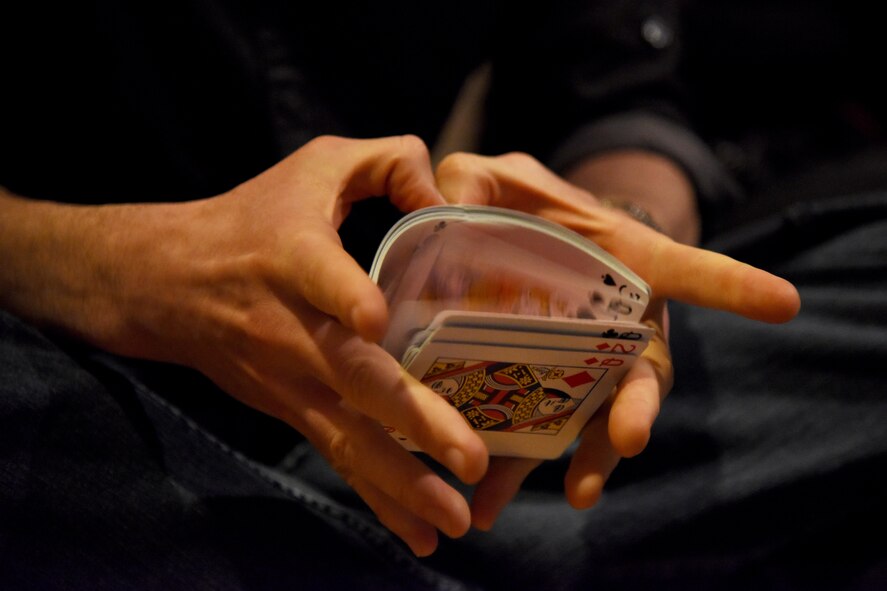 Matt the Knife, magician and mentalist, plays with cards at the theater on Goodfellow Air Force Base, Texas, Dec. 4, 2015. Matt performed a couple card tricks for a group of people after his magic show. (U.S. Air Force photo by Senior Airman Joshua Edwards/Released)
