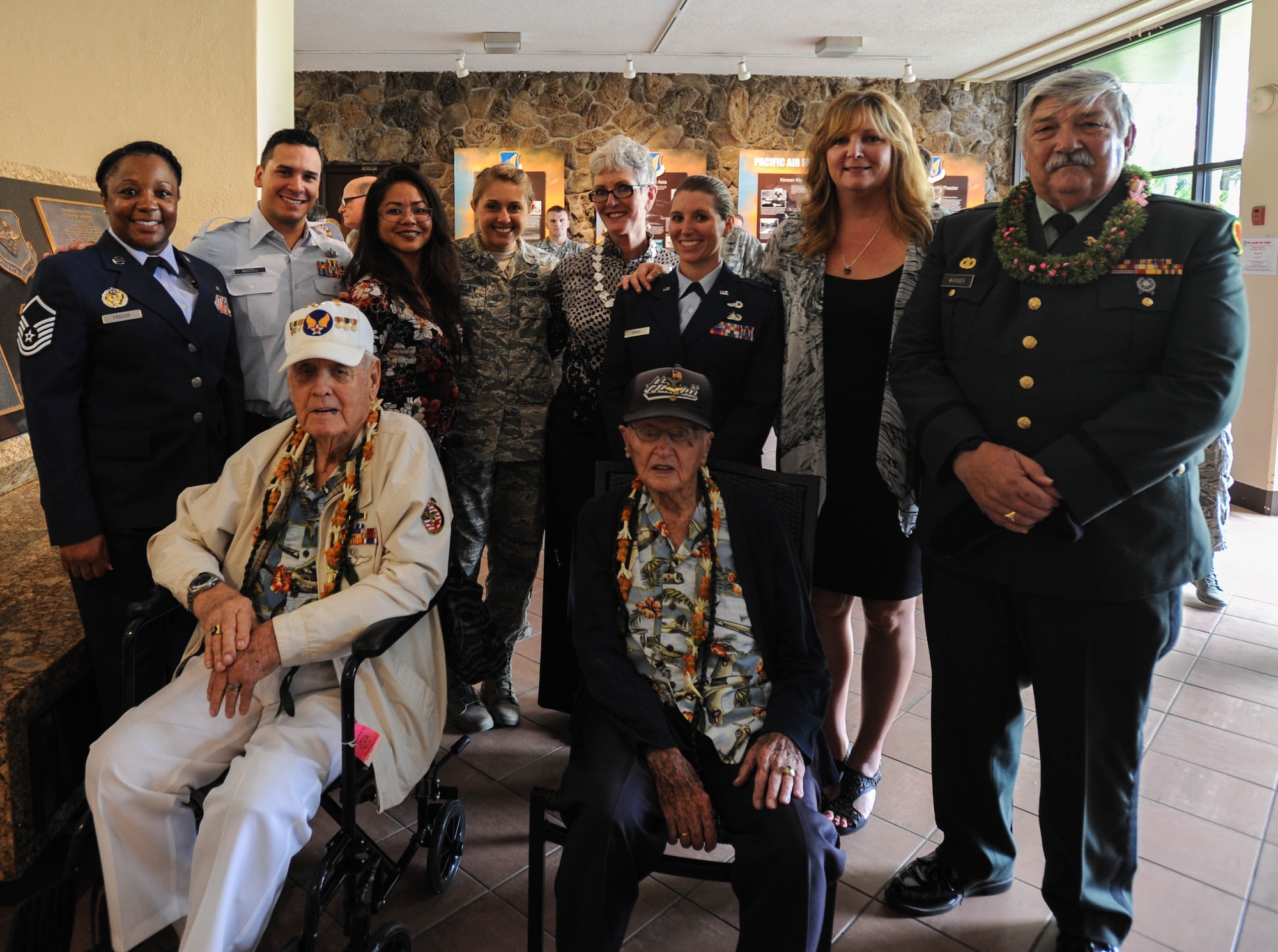 U.S. Air Force Airmen from Pacific Air Forces take a photo with (front left to right) former U.S. Army Air Forces Durward Swanson and retired U.S. Air Force Col. Andrew Kowalski, Hickam Field attack survivors, and retired U.S. Army Maj. Wynn Warner, whose father raised the Hickam Flag before the attacks on Pearl Harbor and Hickam, after a ceremony, Dec. 7, 2015, Joint Base Pearl Harbor-Hickam, Hawaii. The ceremony was held to unveil the new flag case "Old Glory" is to be displayed in. (U.S. Air Force photo by Tech. Sgt. Amanda Dick/Released)