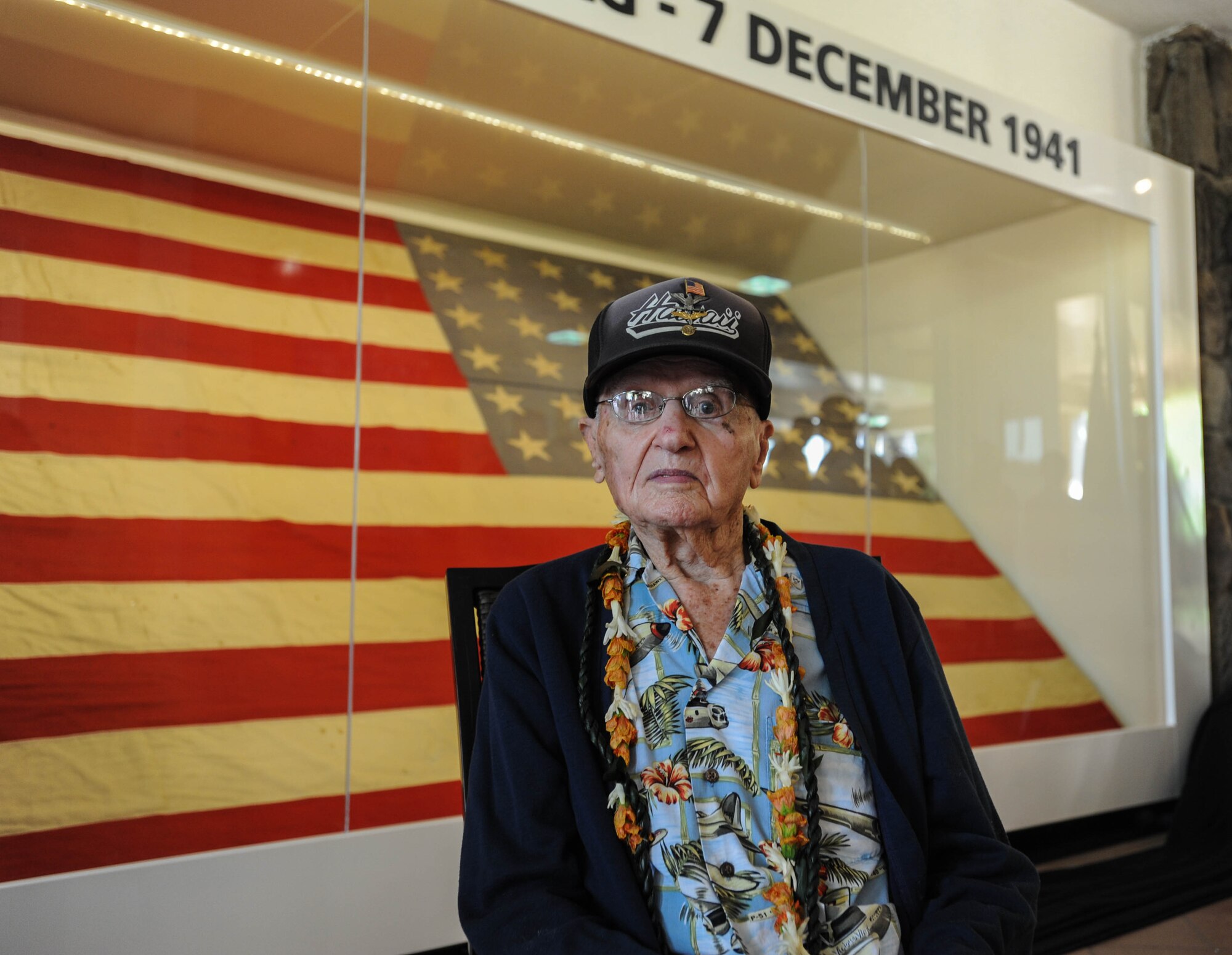 Retired U.S. Air Force Col. Andrew Kowalski, Pearl Harbor-Hickam Field attack survivor, takes a photo with "Old Glory" after a ceremony, Dec. 7, 2015, Joint Base Pearl Harbor-Hickam, Hawaii. The ceremony was held to unveil the new flag case "Old Glory" is to be displayed in. (U.S. Air Force photo by Tech. Sgt. Amanda Dick/Released)