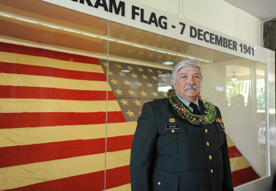 Retired U.S. Army Wynn Warner takes a photo with "Old Glory" after a ceremony, Dec. 7, 1941, Joint Base Pearl Harbor-Hickam, Hawaii. The ceremony was held to unveil the new flag case "Old Glory" is to be displayed in. Warner’s father, U.S. Army Air Forces Sgt. Tracy Warner, raised the flag Dec. 7, 1941, before Pearl Harbor and Hickam Field were attacked. (U.S. Air Force photo by Tech. Sgt. Amanda Dick/Released)