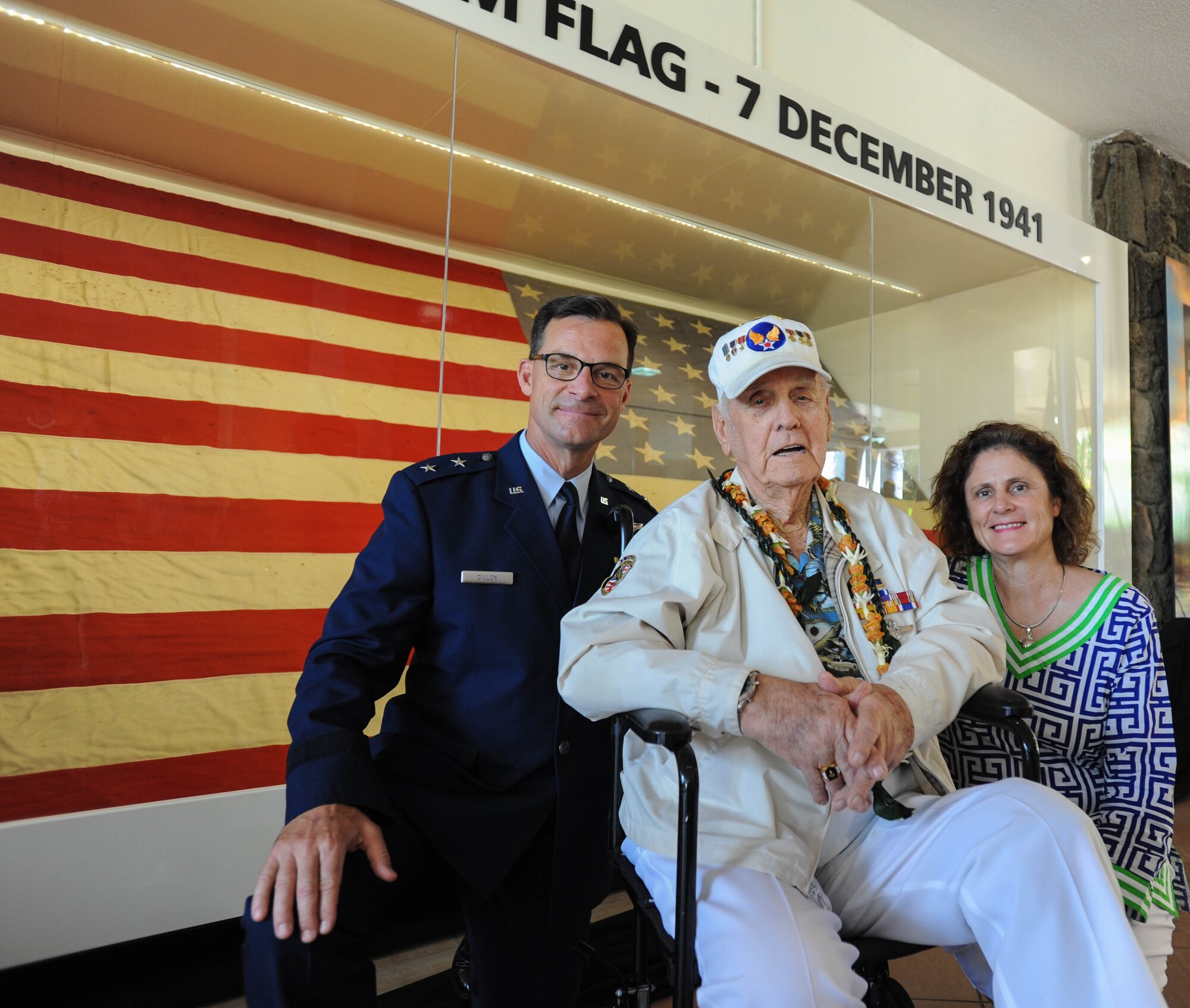 (Left to right) U.S. Air Force Maj. Gen. Mark C. Dillon, Pacific Air Forces vice comander; former U.S. Army Air Forces Tech. Sgt. Durward Swanson, Hickam Field attack survivor; and Sara Dillon, the vice commander's wife, take a photo with "Old Glory" after a ceremony, Dec. 7, 2015, Joint Base Pearl Harbor-Hickam, Hawaii. The ceremony was held to unveil the new flag case "Old Glory" is to be displayed in.(U.S. Air Force photo by Tech. Sgt. Amanda Dick/Released)