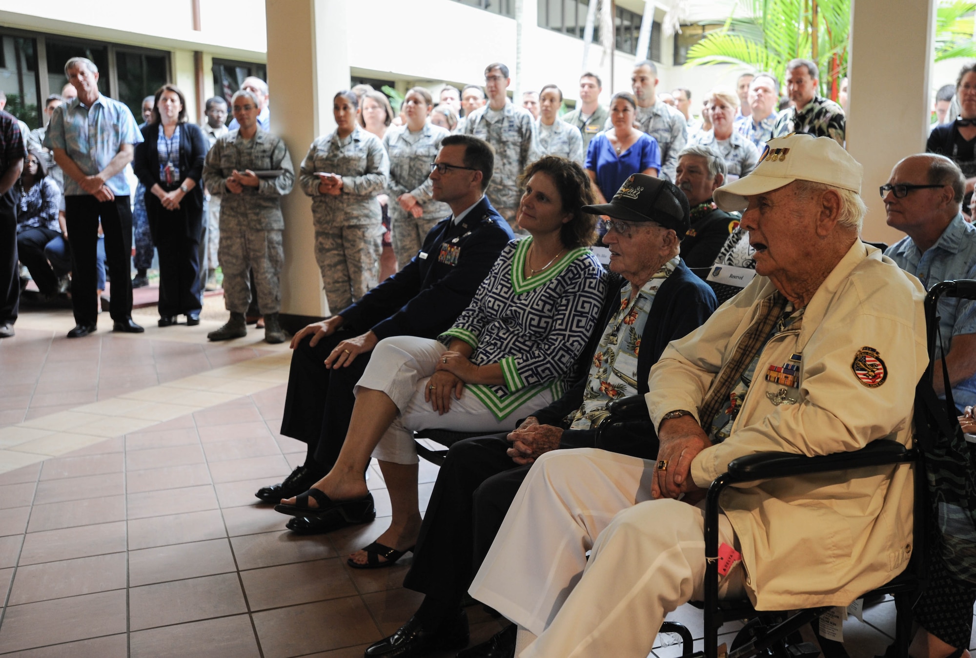 (Seated left to right) U.S. Air Force Maj. Gen. Mark C. Dillon, Pacific Air Forces vice commander; Sara Dillon, the vice commander's wife; retired U.S. Air Force Col. Andrew Kowalski and former U.S. Army Air Forces Tech. Sgt. Durward Swanson, Hickam Field attack survivors, watch a video of "Old Glory" as it is raised in Japan in 1945 during a ceremony, Dec. 7, 2015, Joint Base Pearl Harbor-Hickam, Hawaii. The ceremony was held to unveil the new flag case "Old Glory" is to be displayed in. (U.S. Air Force photo by Tech. Sgt. Amanda Dick/Released)