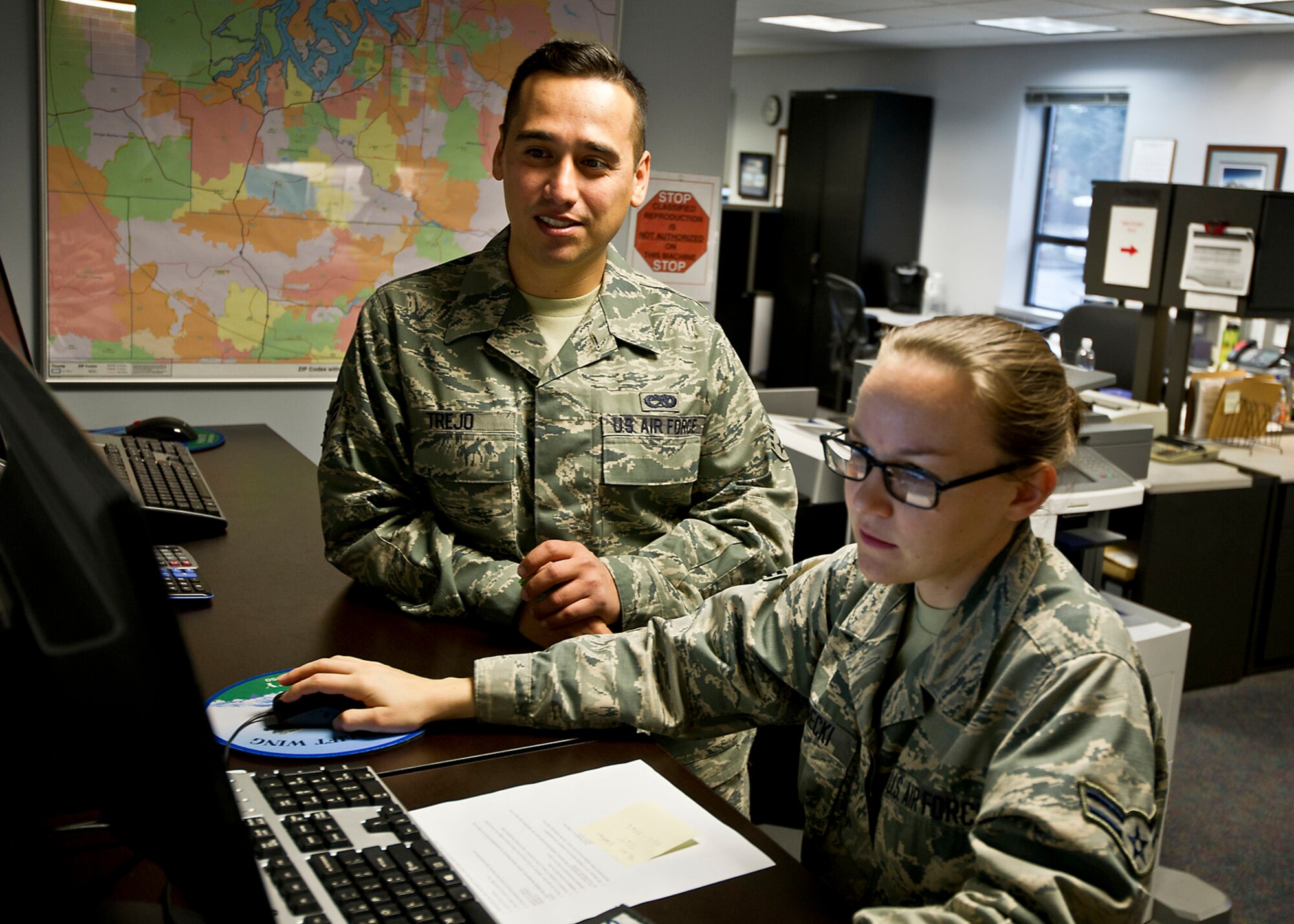 Airman 1st Class Jaqueline Gorecki, 62nd Comptroller Squadron, helps Senior Airman Abraham Trejo, 446th Aircraft Maintenance Squadron, with an eFinance travel voucher. Since the eFinance system cannot be directly approved by Reserve comptrollers, Airmen from the 62nd Airlift Wing come in from 9 a.m. to 3 p.m. on Saturdays of the primary UTA to provide assistance for 446th Airlift Wing Reservists.