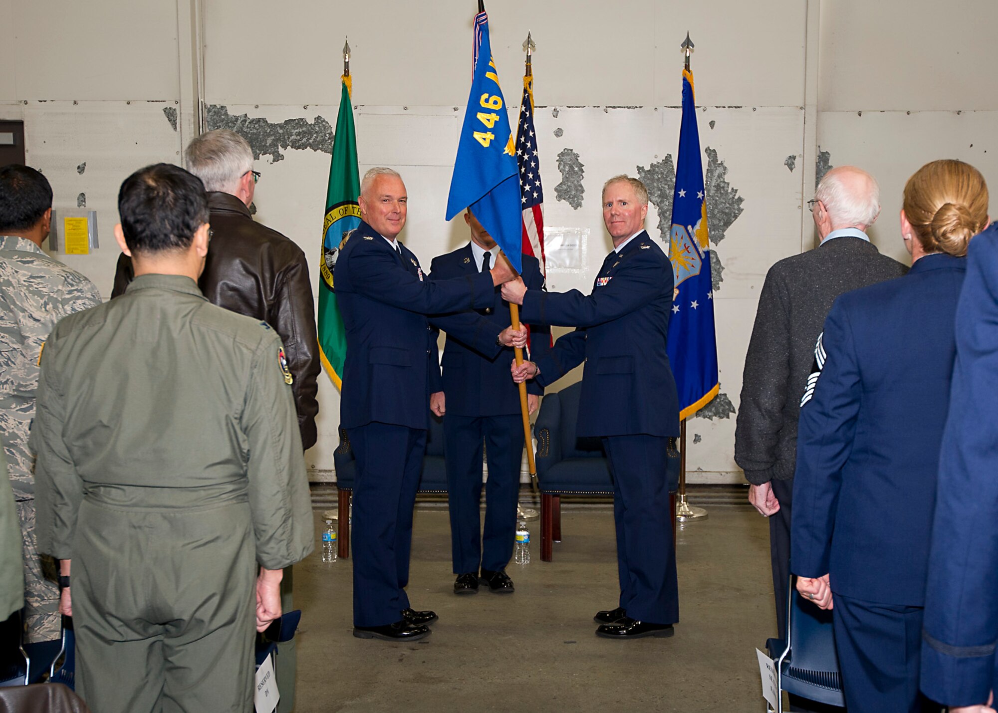 Col. Scott McLaughlin, 446th Airlift Wing commander, hands the 446th Aeromedical Staging Squadron flag to Col. (Dr.) Bruce Neely, the new 446th ASTS commander. After assuming command, Neely thanked his peers and family for the support they've given him throughout his 17 years in aerospace medicine. Neely announced that he believes in the mission of the 446th ASTS and will do everything he can to take care of his Airmen.
