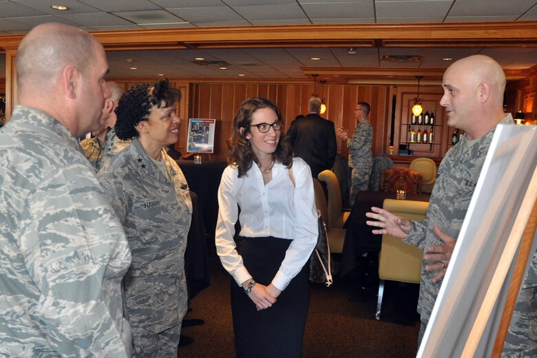 Air Force Reserve 22nd Air Force Commander Maj. Gen. Stayce Harris (second from left); Col. James Dignan, 910th Airlift Wing commander (left) and Ms. Abigail Beniston, City of Youngstown Code Enforcement & Blight Remediation Superintendent (center) listen as Master Sgt. Brian Phillips (right), a structural craftsman assigned to the 910th Civil Engineer Squadron, explains a recent joint blight remediation project during a community welcome luncheon held at Squaw Creek Country Club here, Dec. 4, 2015. Harris was welcomed to the Mahoning Valley by a group of approximately 50 civic leaders as part of her visit to nearby Youngstown Air Reserve Station (YARS), Ohio where she had the opportunity to get an up close look at the 910th’s mission capabilities and the roles that more than 1800 personnel assigned to YARS have in national defense. (U.S. Air Force photo/Master Sgt. Bob Barko Jr.)