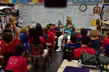 Pearl Harbor survivor Bob Addobati tells Hickam Elementary students stories from his past during the Pearl Harbor Survivor's Association visit, Dec. 3, 2015, on Joint Base Pearl Harbor-Hickam. During the visit, the survivors provided stories to students and faculty, enjoyed a school lunch and were treated to a choral performance by the school's music department. (U.S. Air Force photo by Staff Sgt. Christopher Stoltz/Released)