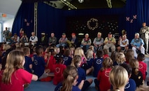 Members of the Pearl Harbor Survivor's Association wait for choral performances to begin during their visit to Hickam Elementary, Dec. 3, 2015, here on Joint Base Pearl Harbor-Hickam.During the visit, the survivors provided stories to students and faculty, enjoyed a school lunch and were treated to a choral performance by the school's music department. (U.S. Air Force photo by Staff Sgt. Christopher Stoltz/Released)