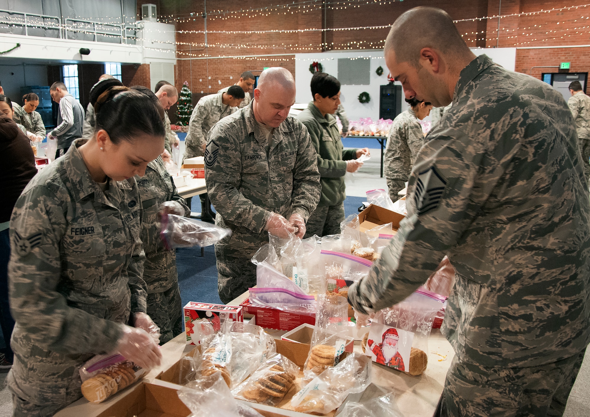 Volunteers make cookie bags for Airmen Dec. 7, 2015, inside the Fall Hall Community Center on F.E. Warren Air Force Base, Wyo. Each bag consisted of 12 cookies and a card wishing Airmen living in the dorms a happy holiday. (U.S. Air Force photo by Senior Airman Brandon Valle)