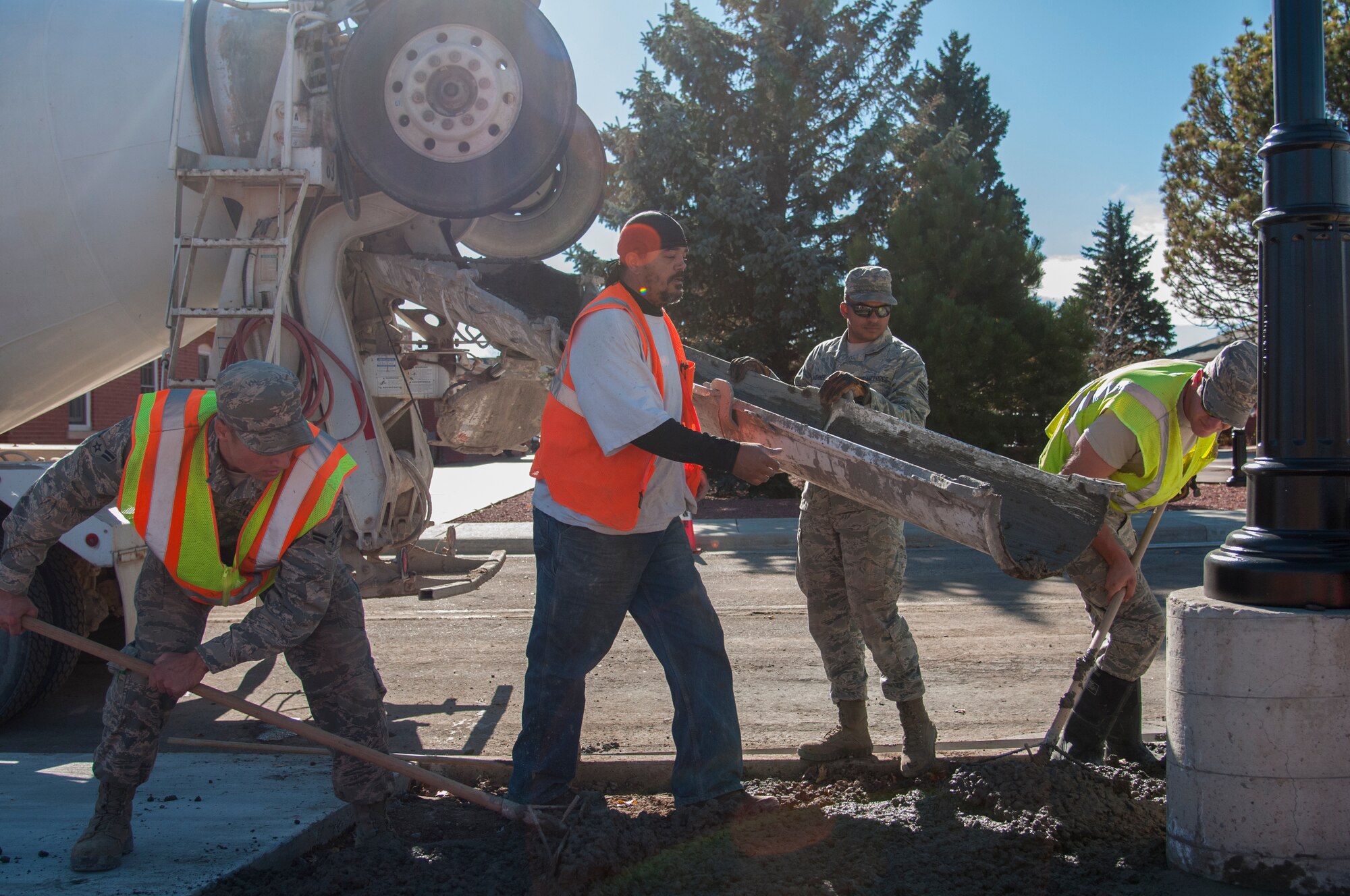 90th Civil Engineer Squadron Airmen work to fill in an area with concrete outside the Chadwell Dining Facility on F.E. Warren Air Force Base, Wyo., Nov. 10, 2015. It takes coordination from many different agencies to take a CE project from cradle to the grave. (U.S. Air Force photo by Senior Airman Jason Wiese)
