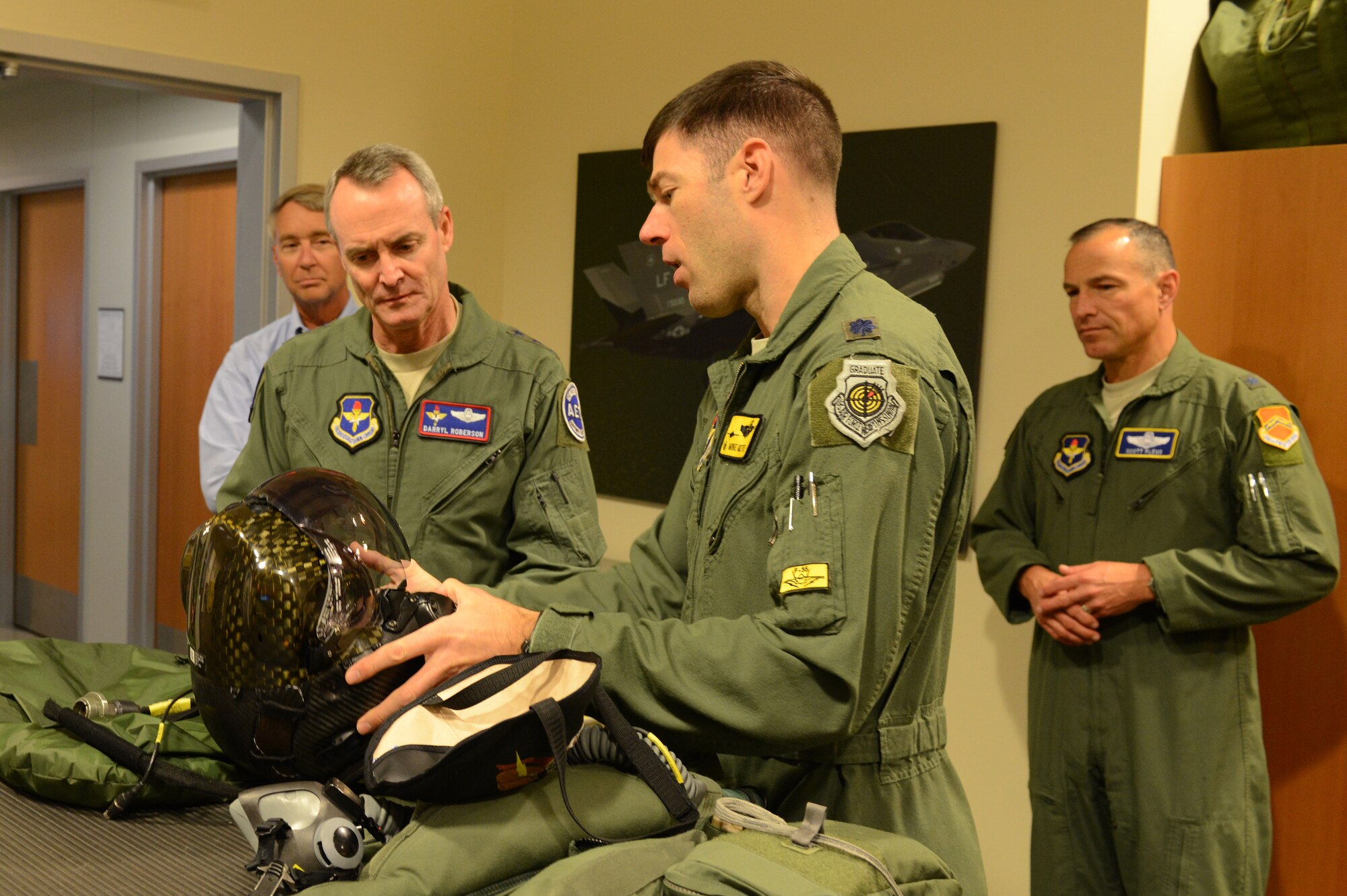 Lt. Col. Michael Gette, 61st Fighter Squadron commander, shows Lt. Gen. Darryl Roberson, commander of Air and Education Training Command, the new helmet for F-35 pilots at Luke Air Force Base, Ariz., Dec. 3, 2015. Roberson toured the Academic Training Center and the 61st Fighter Squadron to see the progress of F-35 training. (U.S. Air Force photo by Senior Airman James Hensley)