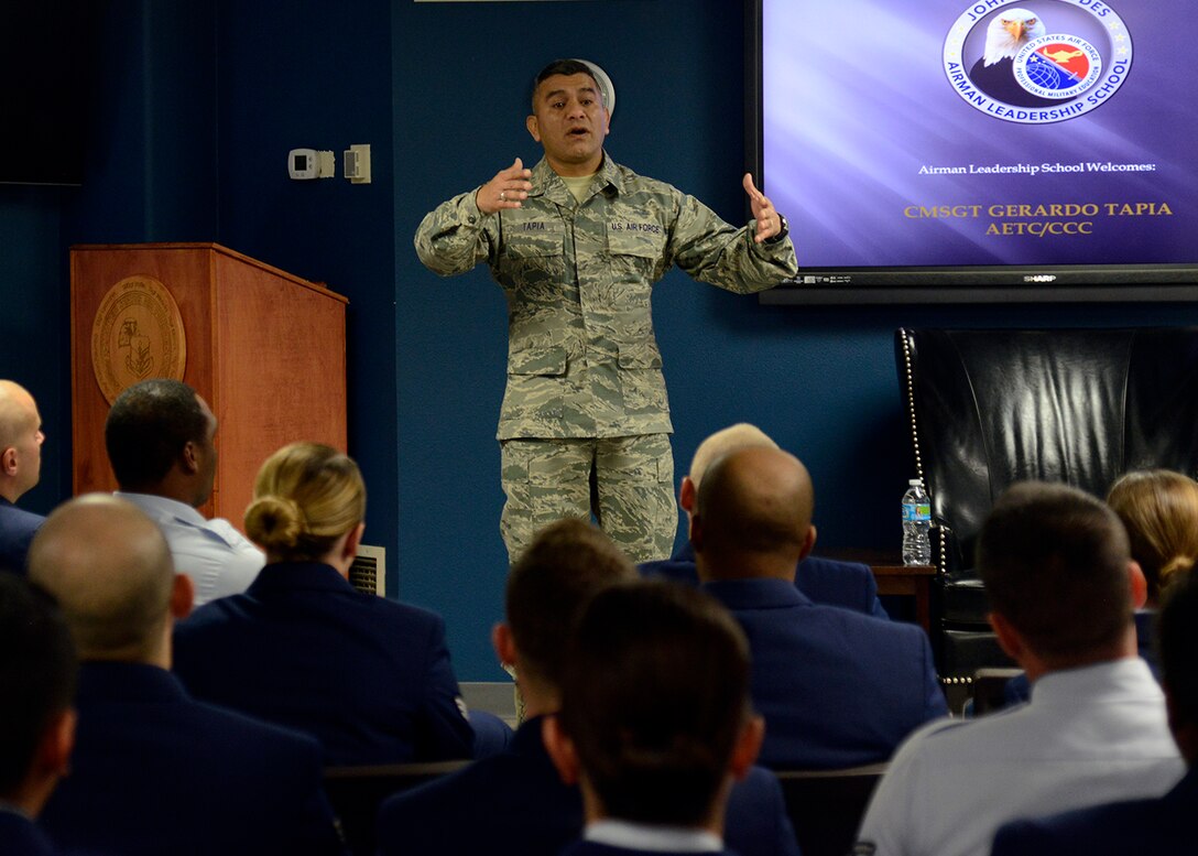 Command Chief Master Sgt. Gerardo Tapia, Air Education and Training Command, speaks to Airman Leadership School students in the ALS building at Luke Air Force Base, Ariz., Dec. 3, 2015. Tapia spoke with the students about leadership and preparing to be supervisors. (U.S. Air Force photo by Senior Airman Devante Williams)