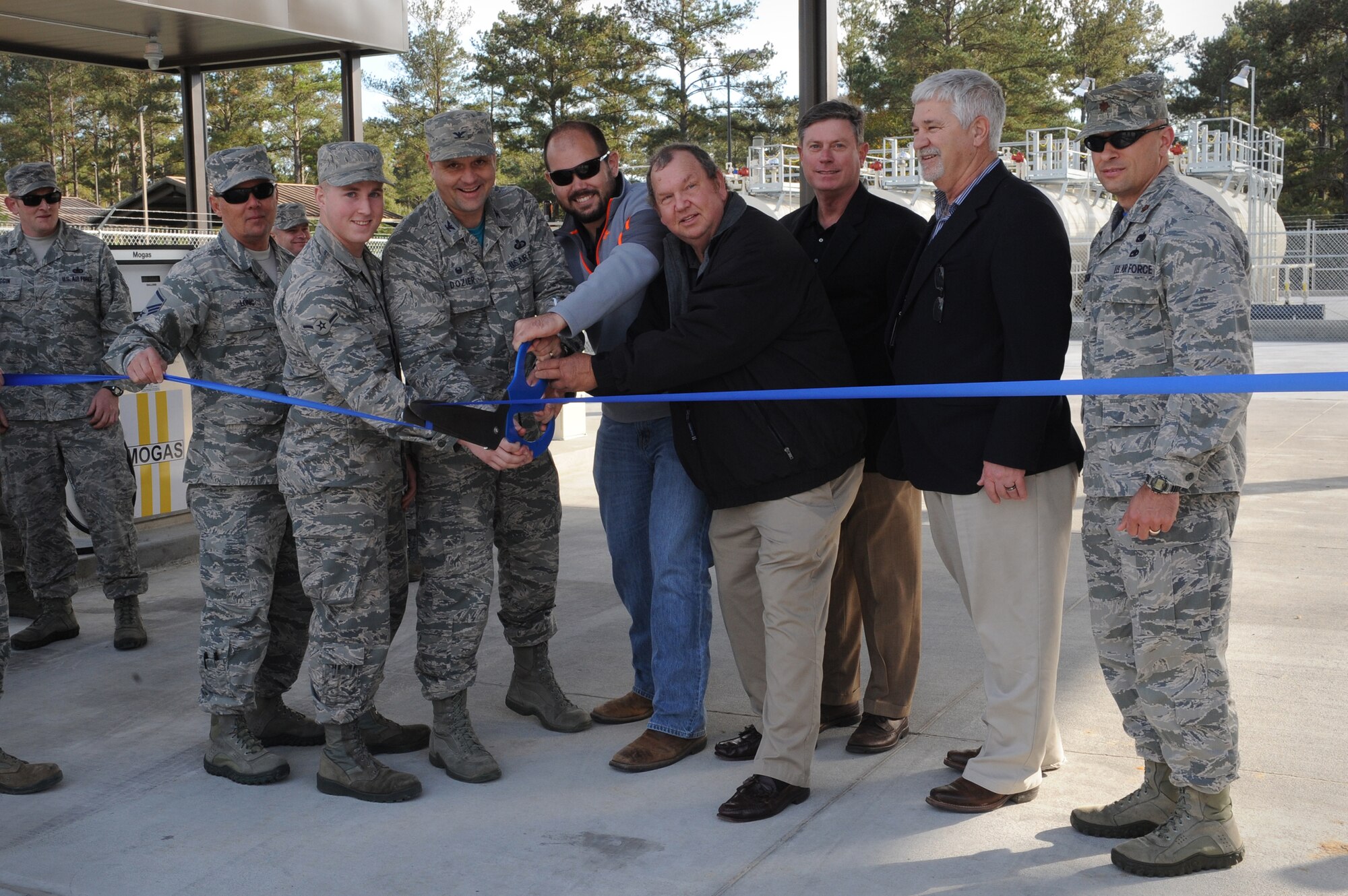 Representatives from the 23d Mission Support Group cut a ribbon at the Military Service Station opening, Dec. 4, 2015, at Moody Air Force Base, Ga. The service station offers diesel and bio-diesel fuel, as well as Ethanol fuel blend 85 and unleaded motor gasoline to all Automotive Information Module Fuel Management system (AIM 2) vehicles and vehicles using the vehicle identification link key (VIL key). (U.S. Air Force photo by Airman 1st Class Kathleen D. Bryant/Released)
