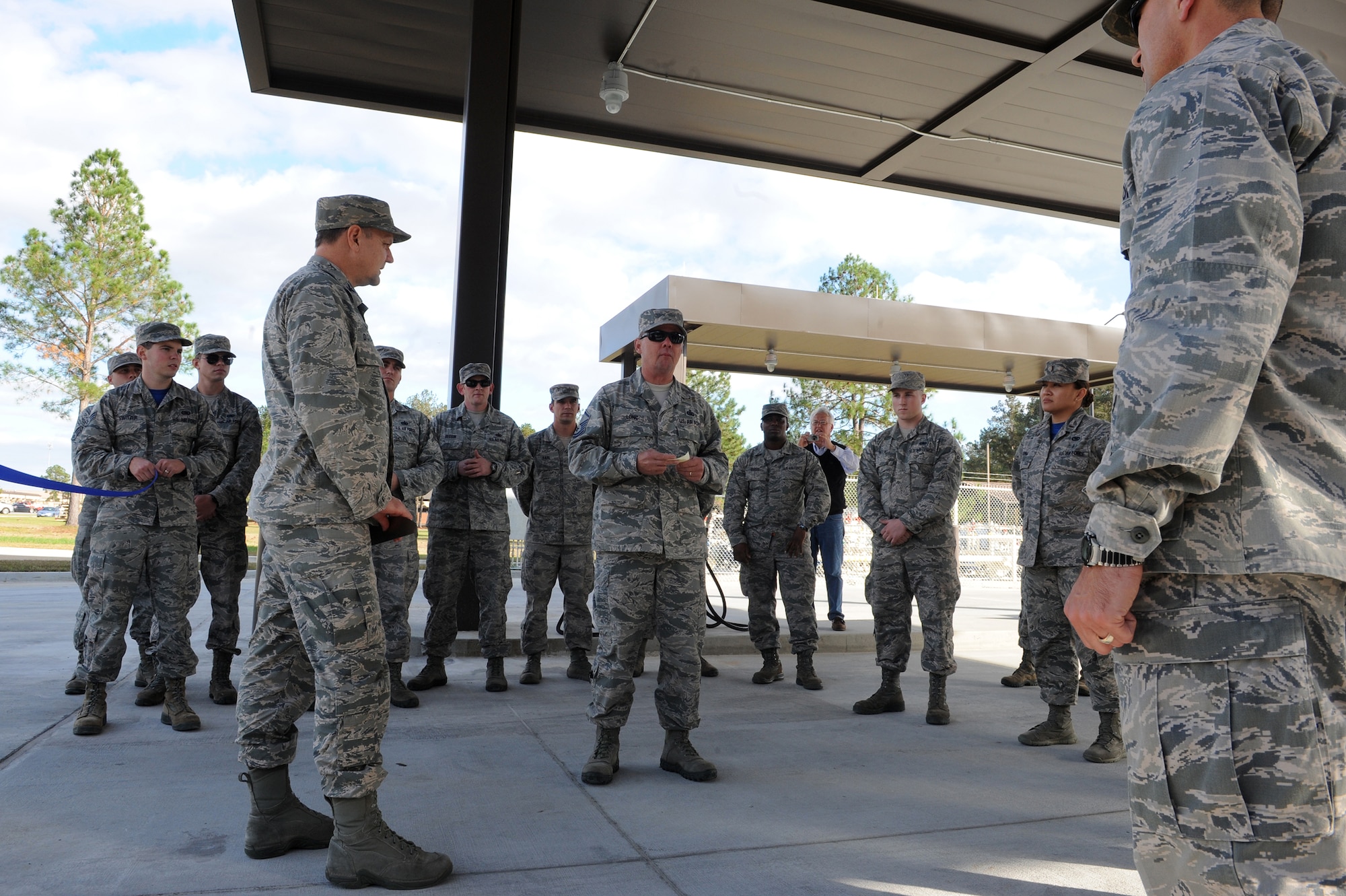 U.S. Air Force Master Sgt. Scott Long, 23d Logistics Readiness Squadron fuels environmental safety office representative, speaks before the ribbon cutting at the Military Service Station opening, Dec. 4, 2015, at Moody Air Force Base, Ga. The service station opened  in November for all Automotive Information Module Fuel Management system (AIM 2) vehicles and vehicles using the vehicle identification link key (VIL key). (U.S. Air Force photo by Airman 1st Class Kathleen D. Bryant/Released)
