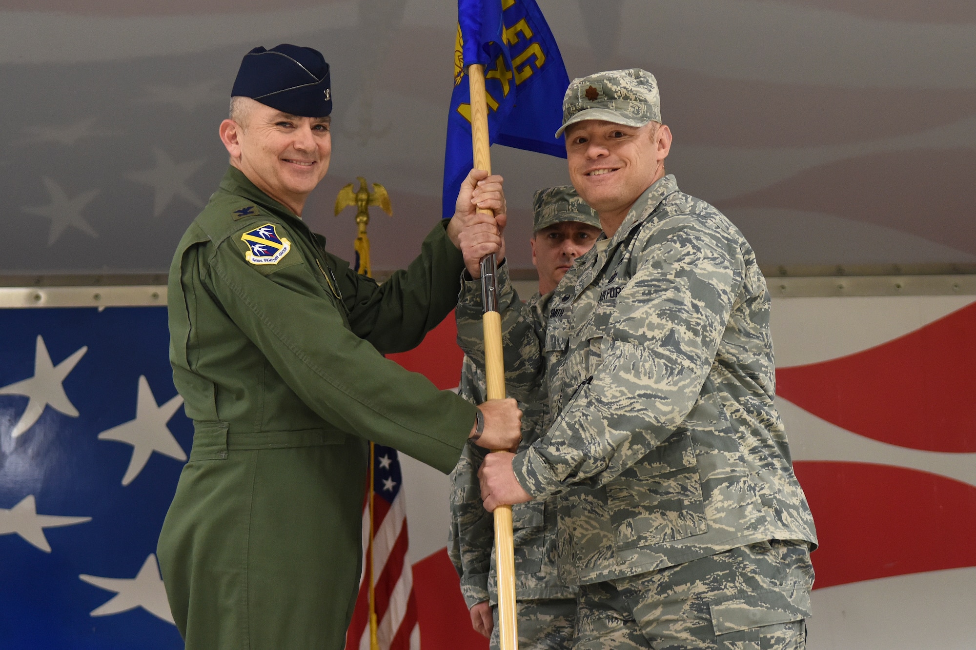 Col. Christopher Freeman (left), 414th Fighter Group commander, passes the guidon to Maj. Paul Smith, 414th Maintenance Squadron incoming commander, during the 414th MXS assumption of command ceremony, Dec. 5, 2015, at Seymour Johnson Air Force Base, North Carolina. Smith assumed command of more than 190 Airmen. (U.S. Air Force photo/Senior Airman Aaron J. Jenne)