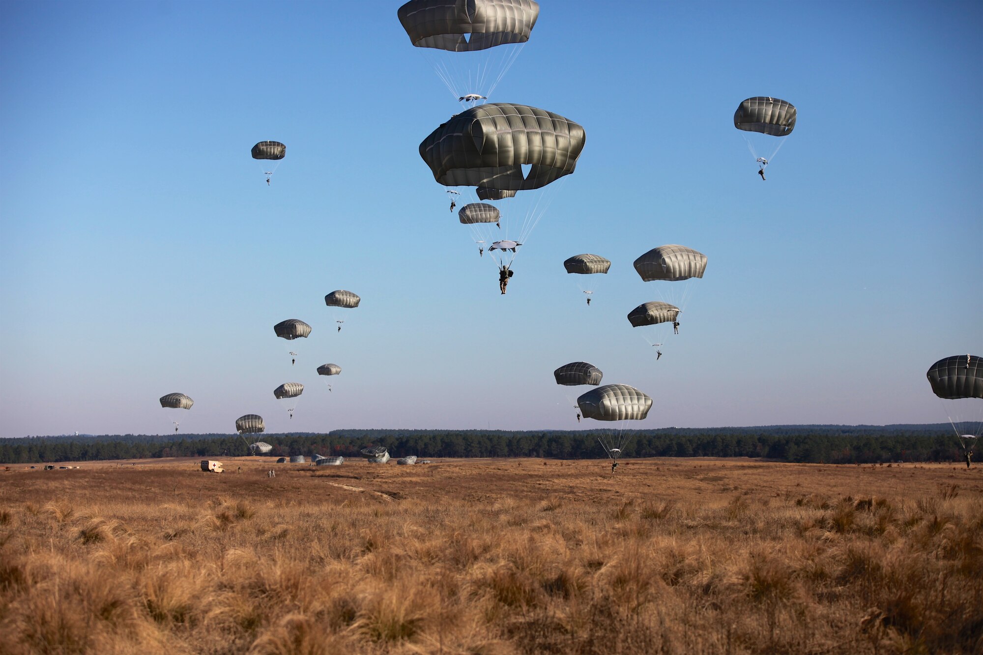 Paratroopers fill the sky at Sicily Drop Zone for the 18th Annual Randy Oler Memorial Operation Toy Drop, hosted by U.S. Army Civil Affairs & Psychological Operations Command (Airborne), Dec. 4, 2015, at Fort Bragg, N.C. Operation Toy Drop is one of the world’s largest combined airborne operations and allows soldiers the opportunity to help children in need receive toys for the holidays. (U.S. Army photo by Sgt. Neil Stanfield)