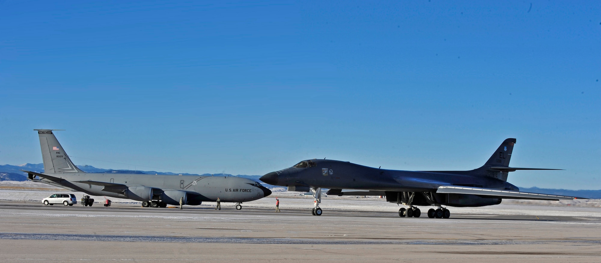 A B-1 bomber taxis past a KC-135 from Selfridge Air National Guard Base, Mich., at Ellsworth Air Force Base, S.D., Dec. 2, 2015. The KC-135 is providing air refueling during the first Large Force Exercise in the Powder River Training Complex. (U.S. Air Force photo by Airman 1st Class James L. Miller/Released)