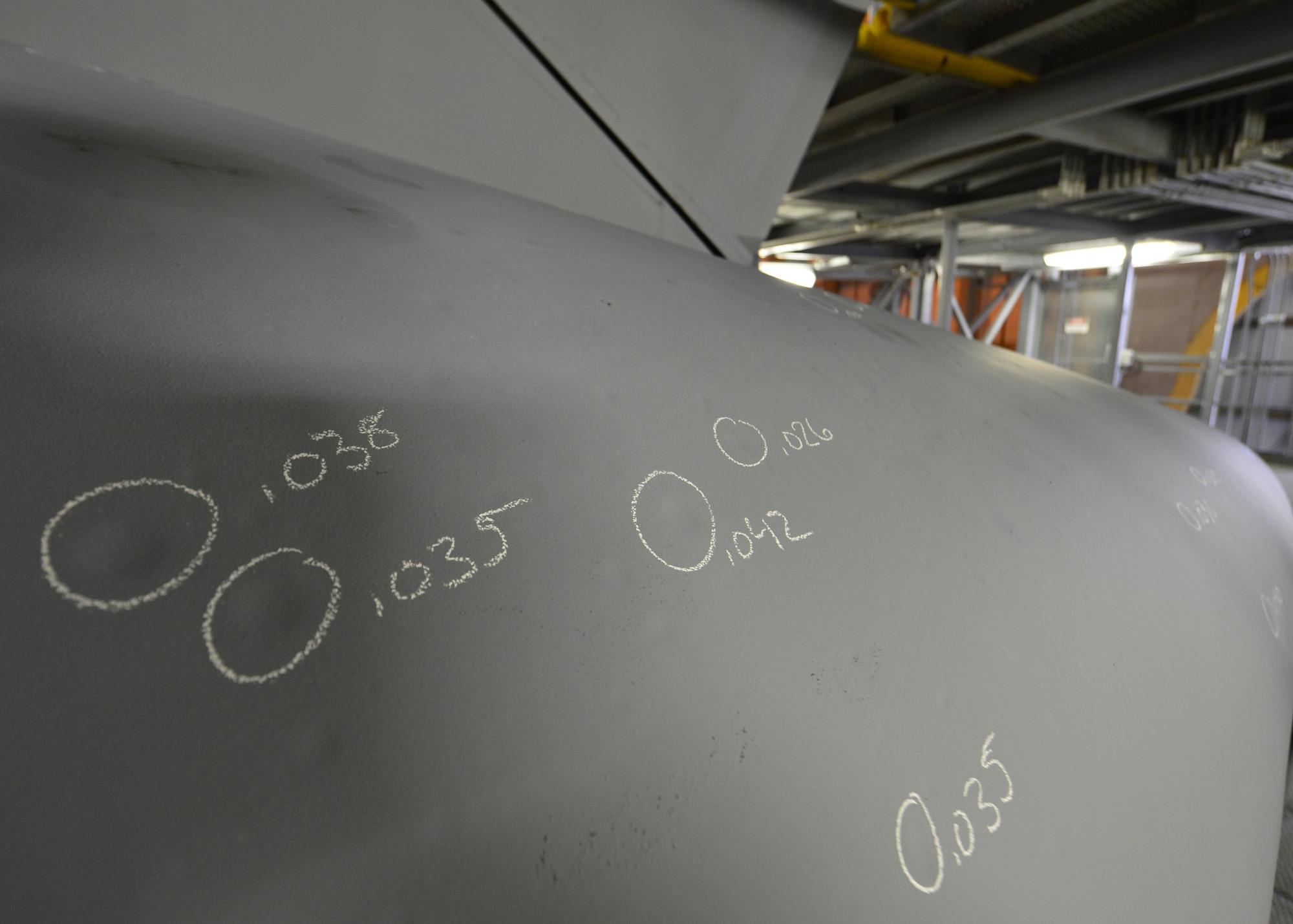 Dents on a C-5M Super Galaxy are circled and measured while the aircraft undergoes a MSG-3 Major inspection Dec. 2, 2015, in the isochronal dock at Dover Air Force Base, Del. Once identified, dents are patched and repaired during the inspection. (U.S. Air Force photo/Senior Airman William Johnson)