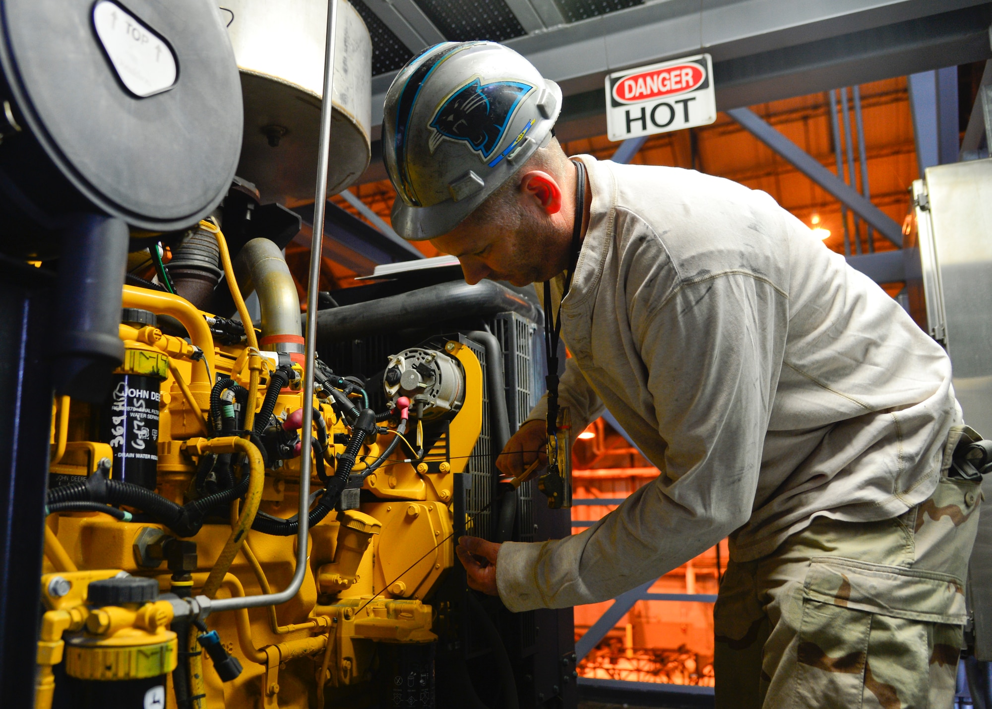 Jason Smith, 512th Maintenance Squadron floor chief, checks the oil on a diesel motor that provides power to the maintenance stands in the isochronal dock Dec. 2, 2015, at Dover Air Force Base, Del. Smith has been performing isochronal inspections for more than 27 years and has worked on every C-5 flying in the Air Force today. (U.S. Air Force photo/Senior Airman William Johnson)
