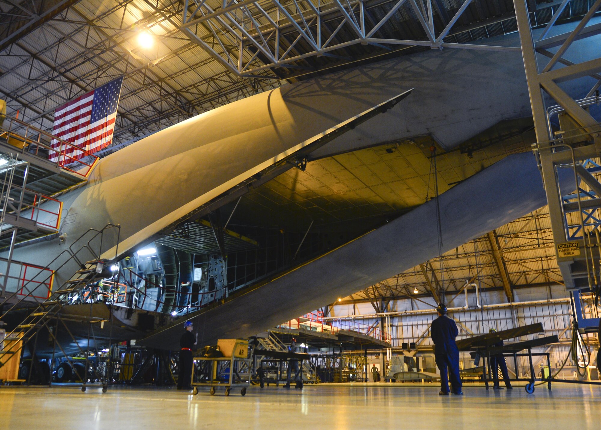 Maintainers from the 436th Maintenance Squadron isochronal dock remove an aft load complex center door from a C-5M Super Galaxy during a Maintenance Steering Group-3 Major inspection Dec. 2, 2015, at Dover Air Force Base, Del. Once removed, sheet metal workers inspect the door for any discrepancies or hazards associated with the door and connecting pieces. (U.S. Air Force photo/Senior Airman William Johnson)